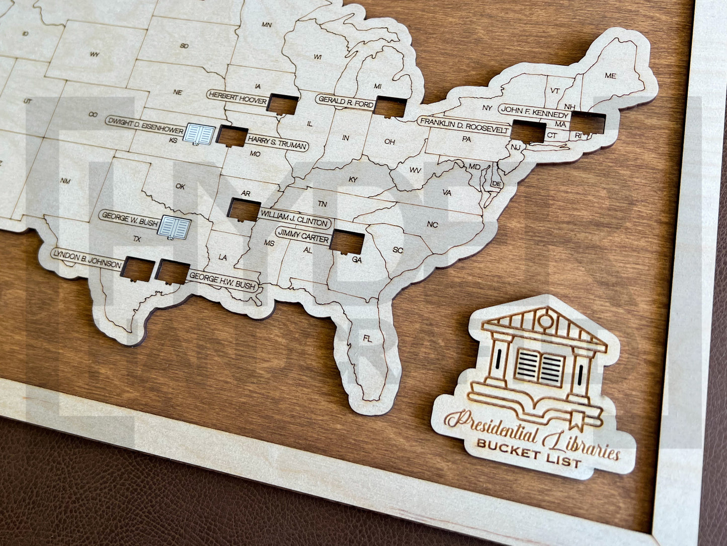 A wall-mounted map showcasing the locations of Presidential Libraries in the United States with a wooden frame and markers. The map is labeled with 'Bucket List' and 'Presidential Libraries'. Close up view