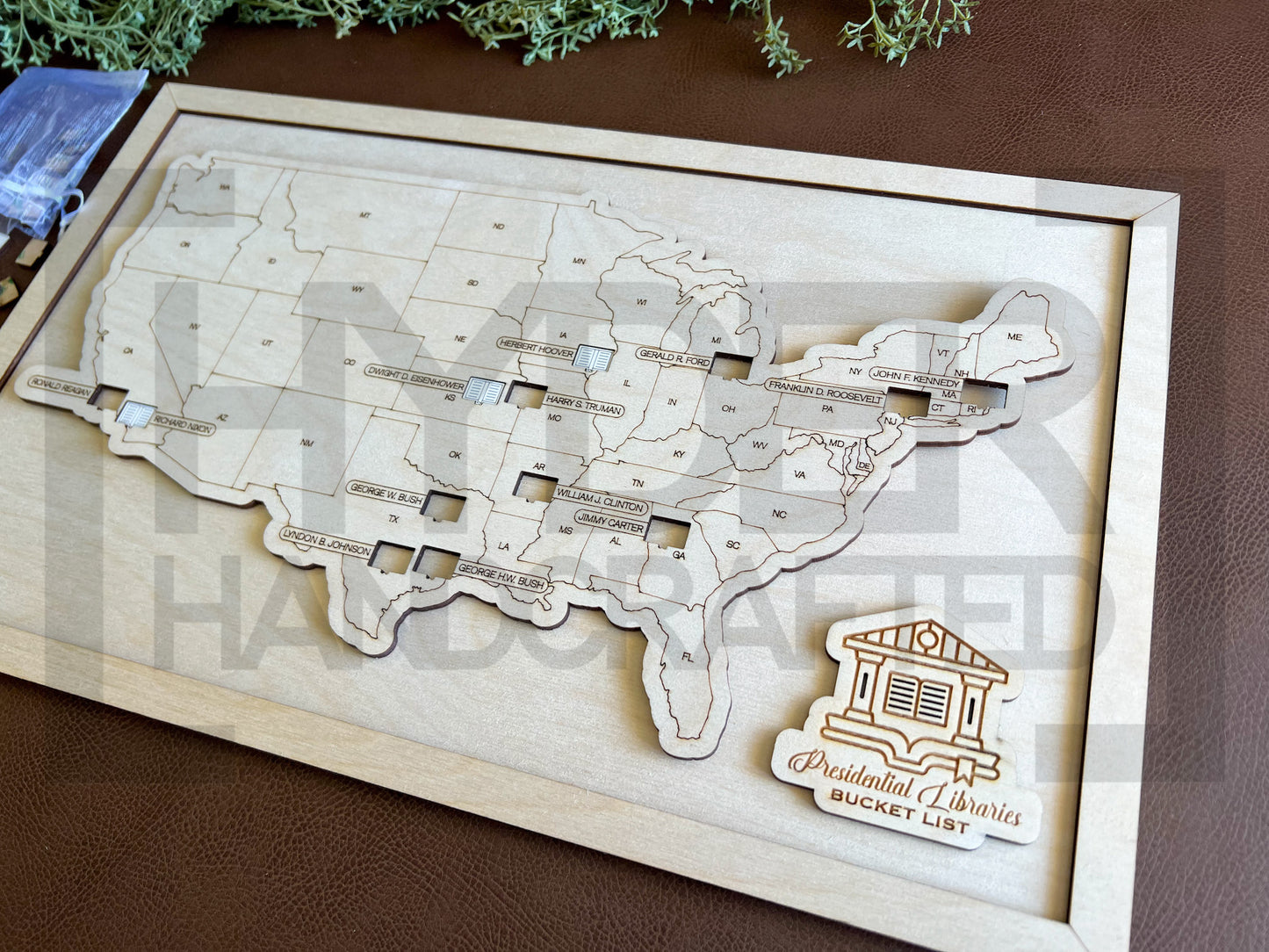 A wall-mounted map showcasing the locations of Presidential Libraries in the United States with a wooden frame and markers. The map is labeled with 'Bucket List' and 'Presidential Libraries'. natural on natural
