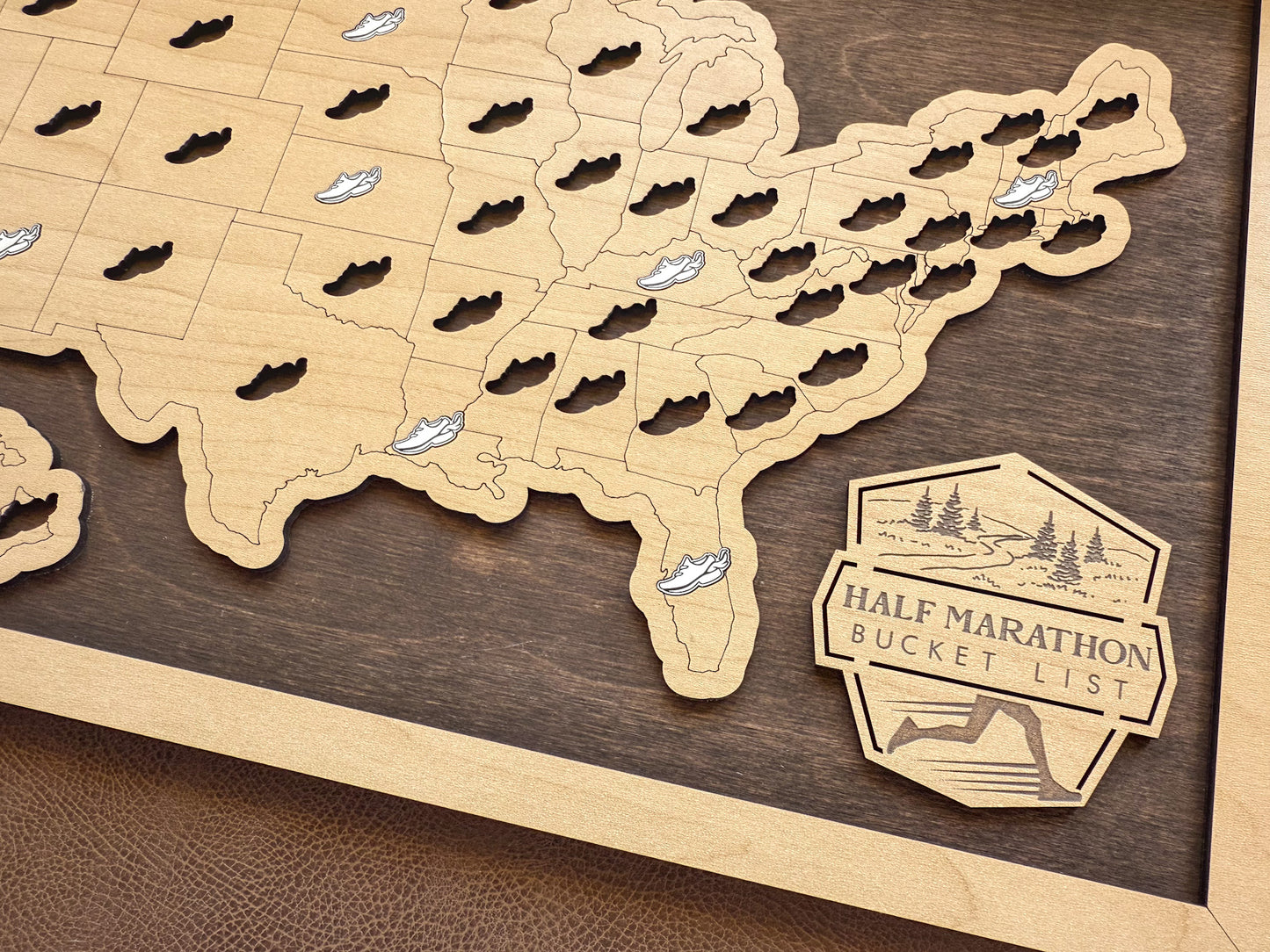 Wooden map of the United States with cut-out states and a 'Half Marathon Bucket List' badge.