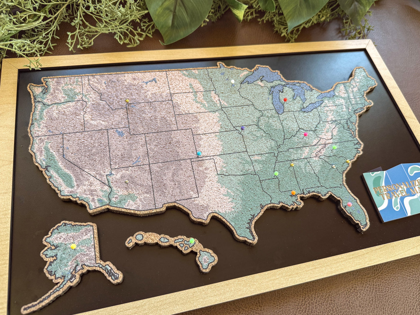 Wooden colorful map of the United States on a dark surface.