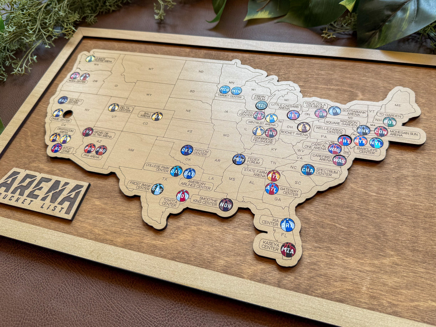 Wooden map of the United States with pins marking locations, basketball map.