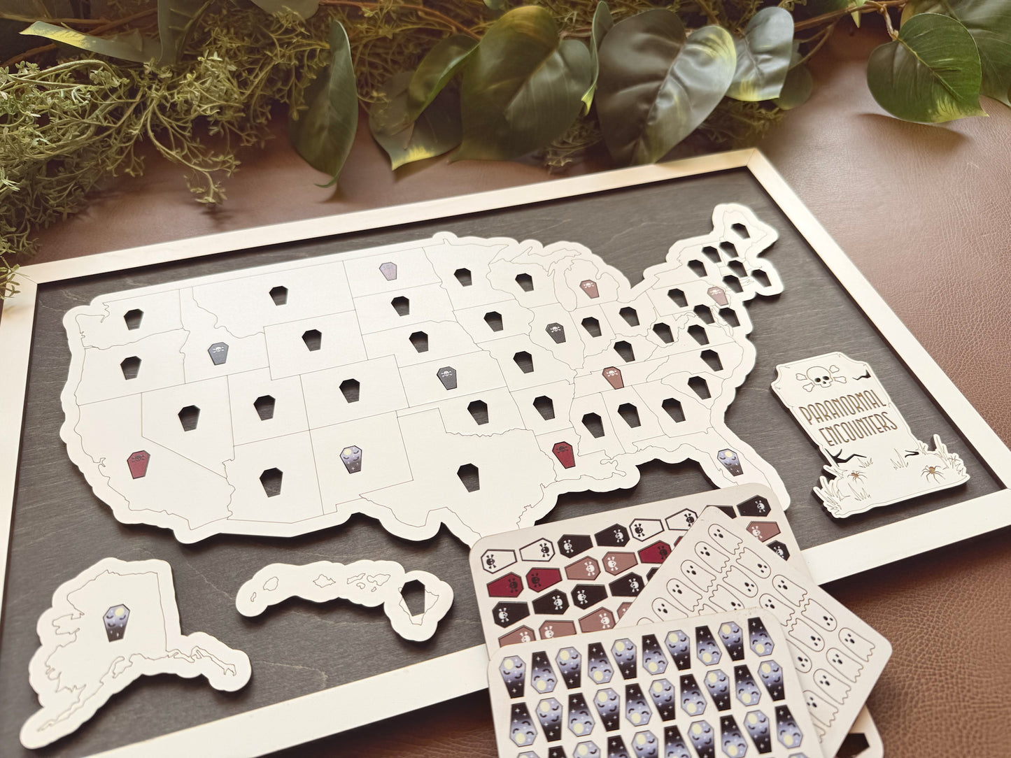 Map of the United States with decorative token pins on a wooden surface