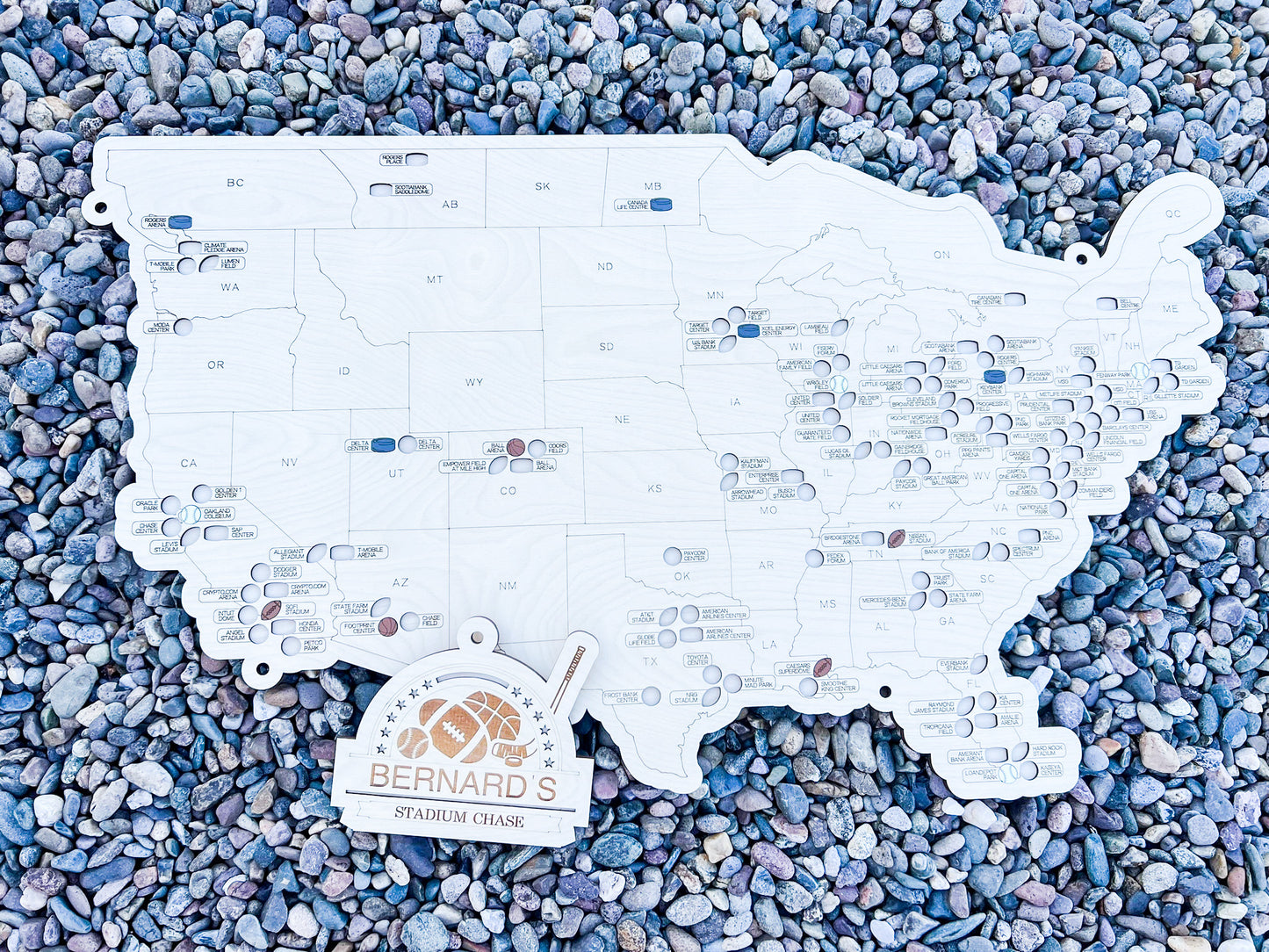 multi Sport wooden map on river rock background