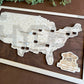 A wall-mounted map showcasing the locations of Presidential Libraries in the United States with a wooden frame and markers. The map is labeled with 'Bucket List' and 'Presidential Libraries'. dark walnut background