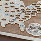 Wooden map of the United States with cut-out fish shapes and 'The Great Fishing Bucket List' logo.
