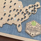 Map of the United States with pickleball court locations and a Pickleball Bucket List badge. close up. blue stain background