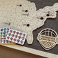 Wooden map of the United States with personalized women's pro tour stickers and a logo on a wooden surface.