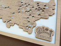 Wooden map of the United States with cutouts and 'Amusement Park Bucket List' plaque.