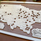 Wooden map of the United States with cut-out holes on a wooden board, featuring 'Amusement Park Bucket List' branding.