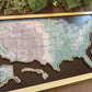 Wooden colorful map of the United States on a dark surface.