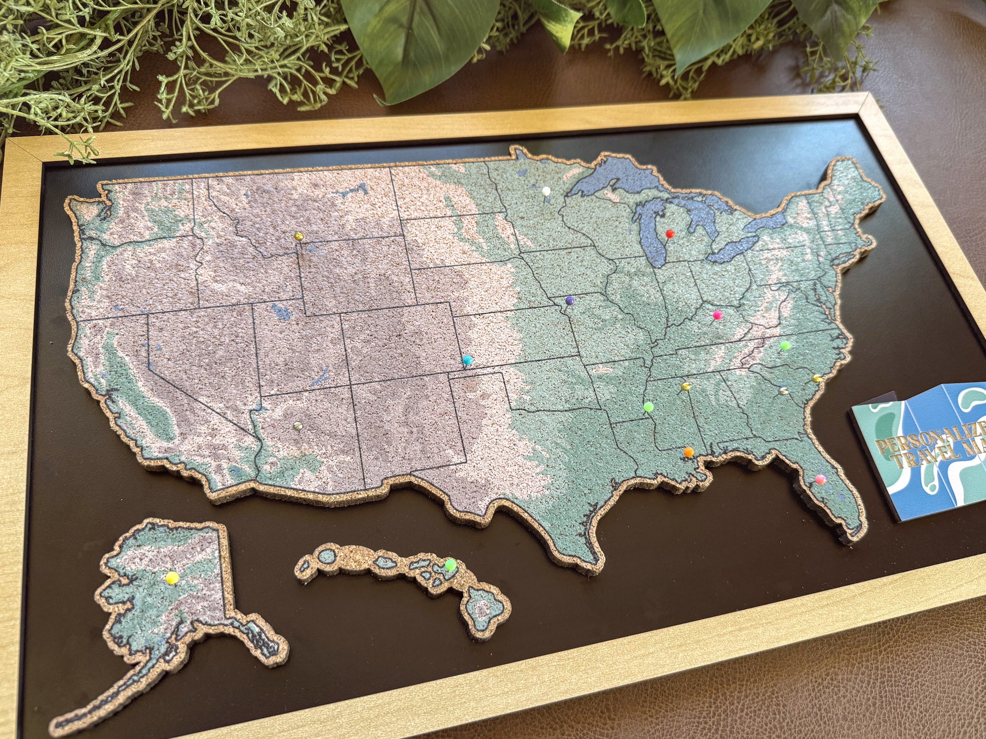 Wooden colorful map of the United States on a dark surface.