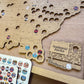 Wooden map of the United States with National Parks and ballparks stickers.