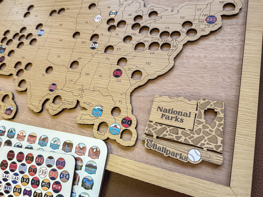Wooden map of the United States with National Parks and ballparks stickers.