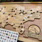 Wooden map with animal stickers and a 'Zoo Bucket List' sign