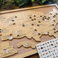 Wooden map of the United States with cut-out states and a card with animal illustrations.
