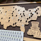 Wooden map of the United States with disc golf course markers on a wooden board.
