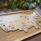 Wooden map of the United States with pins on a wooden board