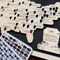 Map of the United States with labeled locations and a 'Paranormal Encounters' card on a dark surface.