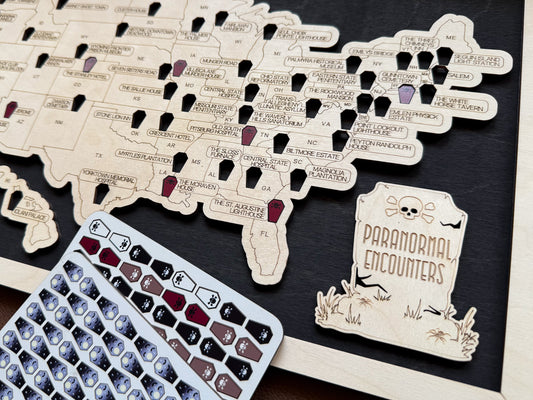 Map of the United States with labeled locations and a 'Paranormal Encounters' card on a dark surface.