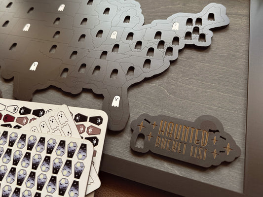 Haunted bucket list game with cards and a map on a wooden surface