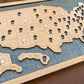 Wooden map of the United States with cut-out states on a blue background