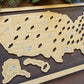 Wooden map of the United States with cut-out shoe holes on a wooden board.