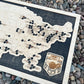 football, baseball, basketball multi sport map on dark wood backing.
